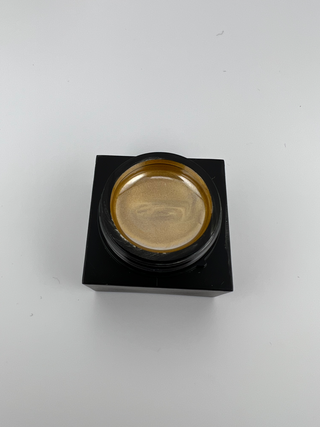 Gold Metal art gel in a 5g square jar with lid off displaying gold gel consistency